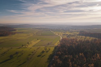 The wide view of a rural landscape with fields and a wide sky