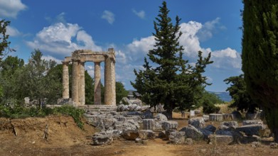 Ruins of an ancient temple against a blue sky with trees and scattered stones, Ancient Zeus
