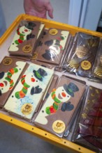 Various chocolate bars with painted snowmen in decorative packaging, Christmas baking, Haselstaller