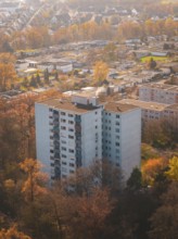 Large apartment block surrounded by autumn trees from above in an urban area, MÃ¼hlacker, Enzkreis,