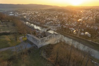 Medieval castle on a river surrounded by a town at sunset, MÃ¼hlacker, Enzkreis, Germany