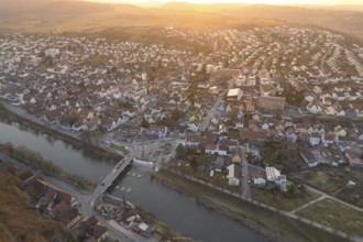 City along a river, illuminated by soft evening sun, with harmonious architecture, MÃ¼hlacker,