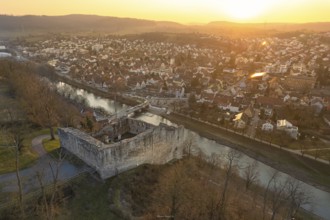 Medieval ruin on a river, with illuminated cityscape at dusk, MÃ¼hlacker, Enzkreis, Germany