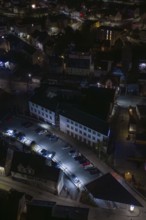 Building with illuminated parking lot in a nocturnal environment, Nagold, Calw district, Germany