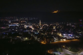 Panoramic view of illuminated city at night with church and castle in the background, Nagold, Calw