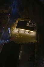 Illuminated gas station on a street at night in a town, Nagold, Calw district, Germany