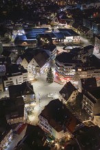 Night view of a city center with illuminated buildings and a Christmas tree, Nagold, Calw district,
