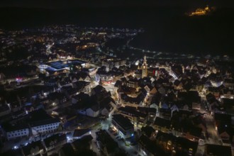 Night view of a city with illuminated buildings and a fortress on a hill, Nagold, Calw district,