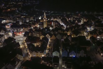 Night panorama of a city with a centrally located, illuminated church tower, Nagold, Calw district,