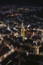 Night view of a city with illuminated buildings and a central church tower, Nagold, Calw district,