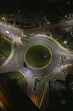Night view of an illuminated roundabout with passing cars, Nagold, Calw district, Germany