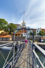 Female walker on bridge for pedestrians between ChristiansÃ¸ and FrederiksÃ¸, Christiansö and