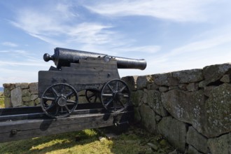 Cannon looking over stone wall at the sea, fortress, Kongens Bastion, Königsbastion, ChristiansÃ¸,
