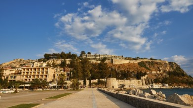 Promenade overlooking the sea and historic buildings under clear skies, Nauplion, Nafplion,