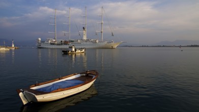 Nauplion harbour, sailing ship and small boat in harbour at sunset in calm water, Nauplion,
