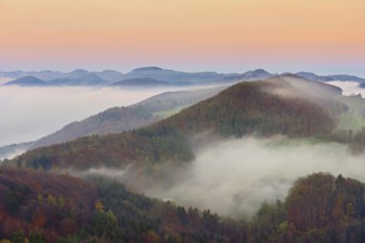 View from the Gisliflue of the Jurassic foothills covered in fog, Wasserfluh, in the light of dawn,