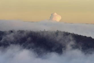 View from the Gisliflue of the Jurassic foothills covered in fog in the light of the rising sun,