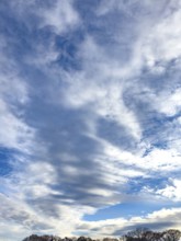 Cloud cover just in front of dusk with linear Altostratus clouds above it Cumulus mediocris with
