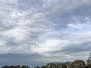 Extensive cloud cover with large layer of altostratus clouds with bag-shaped bulges at the bottom