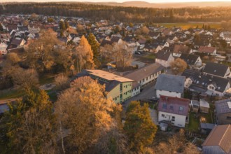 Rural area with houses and autumn trees in a warm evening atmosphere, Althengstett, Calw district,