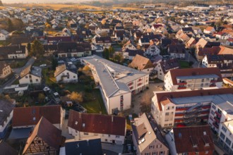 Aerial view of a village with many residential buildings and a community building, Althengstett,