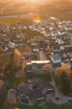 View of residential area from the air with autumn trees and sunset atmosphere, Althengstett, Calw