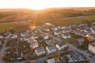 Aerial view of a suburb at sunset with numerous houses and roads, Althengstett, Calw district,