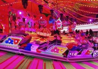 People on the Musik-Express ride at the All Saints Fair, the biggest old town fair in Europe,