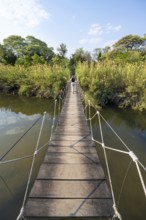 Toruist on the Kavango River, suspension bridge at Camp Kwando, Zambezi region, Caprivi Strip,