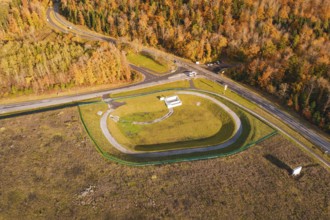 Test site with surrounding forest and road junction in autumn landscape, new Lindenrain industrial