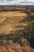 Autumn scene from the air with open landscape, colorful forest and fields, new Lindenrain