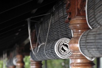 Close-up view of rolled bamboo blinds and artfully turned wooden posts, Heritage Hotel Privacy,