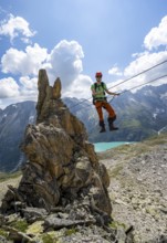 Crocodile rock formation, mountaineer on rope bridge in the Crocodile Mountain Lake via ferrata on