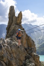 Crocodile rock formation, mountaineer on rope bridge in the Crocodile Mountain Lake via ferrata on