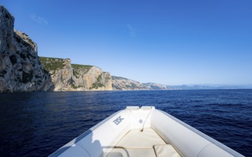 Motorboat trip along the picturesque rocky coast, cliffs and blue sea, Golfo di Orosei, Baunei,