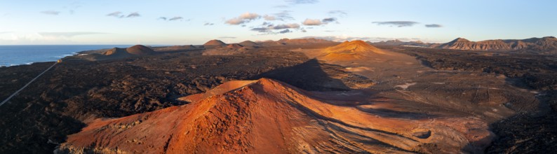 Picturesque volcanic landscape in evening light, red volcano MontaÃ±a Bermeja between lava fields,