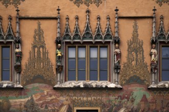 Painted faÃ§ade with 4 medieval human sculptures, fresco cycle, window, town hall, old town, Ulm,