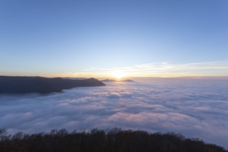 Sunset over the sea of fog from Beurener Fels to Hohenneuffen Castle, Swabian Alb,