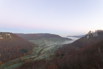 Sunrise with fog in the Neidlinger Valley with a view of the Reussenstein castle ruins. Swabian