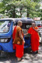 Buddhist monks talking near a tuk-tuk, Kandy, Sri Lanka