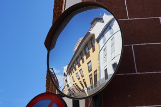 Architecture reflected distorted in a convex street mirror, UNESCO World Heritage Old Town of San