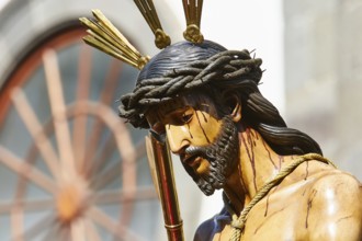Good Friday procession, close-up of Jesus statue with crown of thorns and suffering expression,