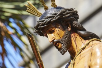 Good Friday procession, side view of a Jesus statue with crown of thorns, in sunshine, UNESCO World