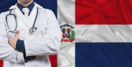 Male doctor with stethoscope on Dominican Republic flag. Doctor holding stethoscope on Dominican
