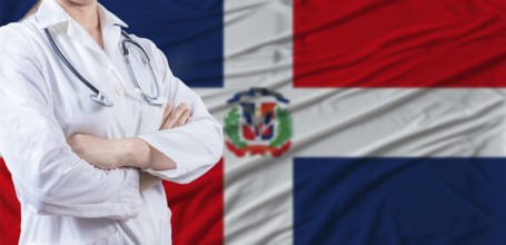 Doctor with crossed arms on Dominican Republic flag. Dominican health and care concept. Female
