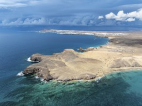 Coast with Playa de Papagayo beach and Playa Caleta del Congrio and blue sea, dry landscape of Los