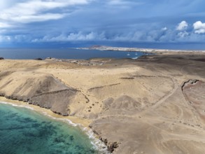 Coast with Playa Caleta del Congrio beach and blue sea, arid landscape of Los Ajaches Natural Park,