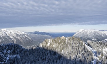 Snowy forest and Kreuzeckhaus mountain hut in the Garmisch Classic ski area in winter, Wetterstein