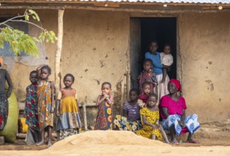 African woman and children in the house entrance, in a Sadaani village, Tanga, Tanzania
