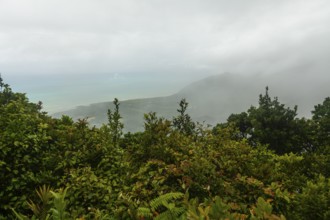 Distant tropical view from Mount Sorrow across valley and bay to where the Great Barrier Reef meets